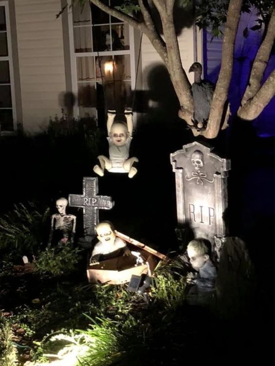 a stylish Halloween yard decoration of tombstones, scary babies and kids is a cool idea you can realize