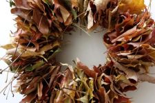 a super simple fall wreath amde of leaves adn twigs is a lovely idea for the fall, make one yourself
