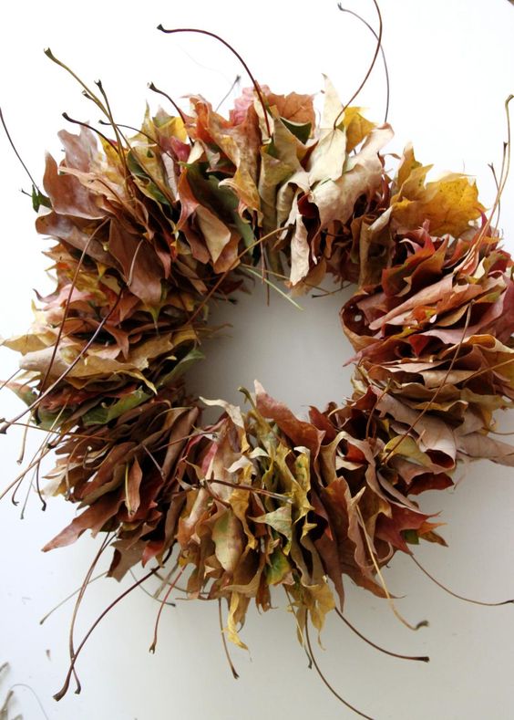 a super simple fall wreath amde of leaves adn twigs is a lovely idea for the fall, make one yourself