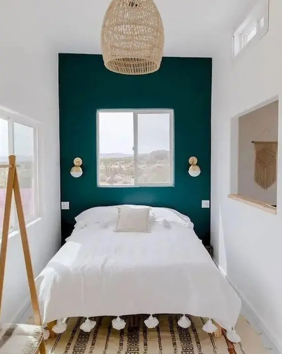 a tiny bedroom enlargened with a neutral color scheme, a mirror and several windows and feels welcoming
