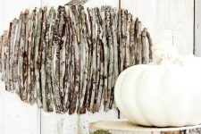 a twig pumpkin on a board is an easy rustic-inspired fall decoration you can make yourself