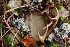 a very textural twig fall wreath with antlers, moss, dried blooms, burlap and a burlap bow will bring a woodland feel to your space