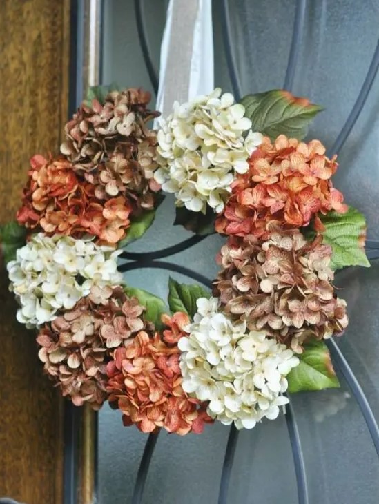 a vintage-inspired faux hydrangea wreath in brown, rust and white on a silk ribbon is a very stylish idea for decor