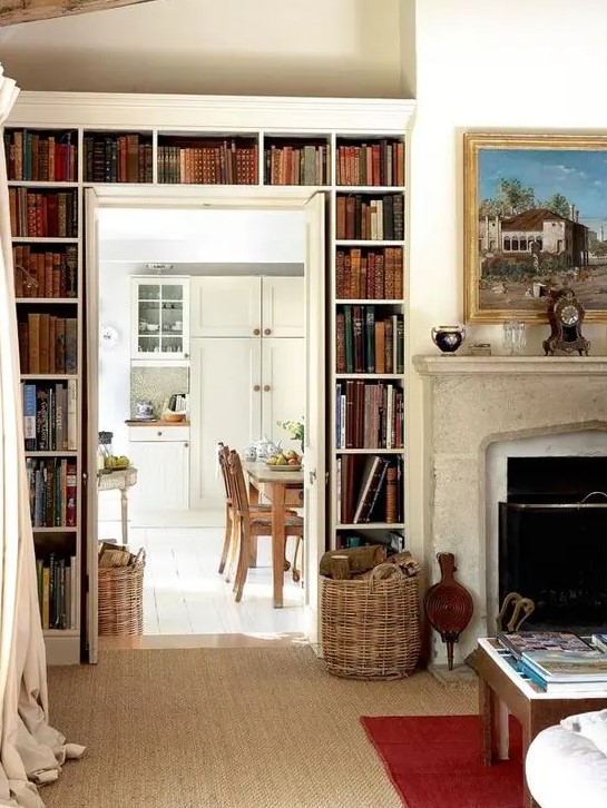 a vintage space with open bookshelves over the doorway is a lovely idea to store books and make the space look cool and chic