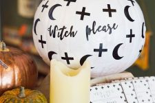 a white Halloween pumpkin with half moons, crosses and calligraphy is very easy to repeat, make one for Halloween