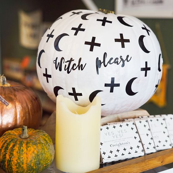 a white Halloween pumpkin with half moons, crosses and calligraphy is very easy to repeat, make one for Halloween