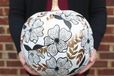 a white pumpkin decorated with black and gold sharpies looks pretty and will add chic to your Halloween decor