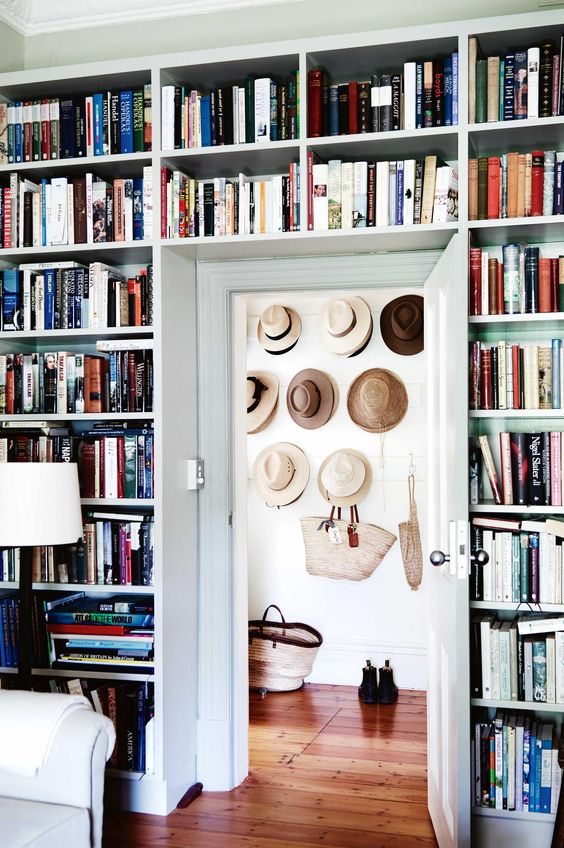 a whole wall taken by bookcases including the space over the door is a smart solution if you have a lot of books at home