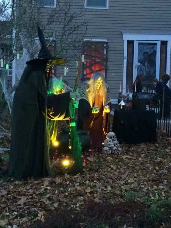 a witch Halloween scene for a yard, with lights, skulls and a cauldron is a cool idea for outdoors