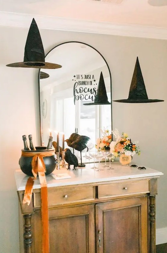 an arched mirror with a simple black letter sticker and witch hats floating around is amazing for Halloween