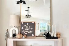 an arched mirror with cheesecloth and paper bats is a simple and cool solution for Halloween