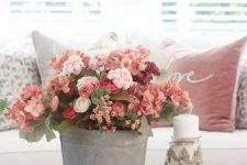 an elegant and romantic red, pink and burgundy faux flower arrangement in a bucket is a great fall decoration