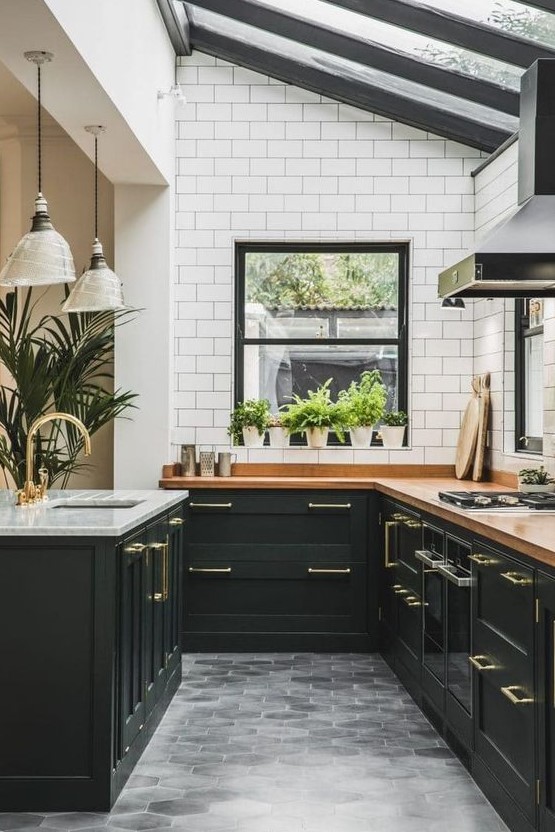 an elegant art deco kitchen in black, with butcherblock countertops, white subway tiles and a glazed ceiling