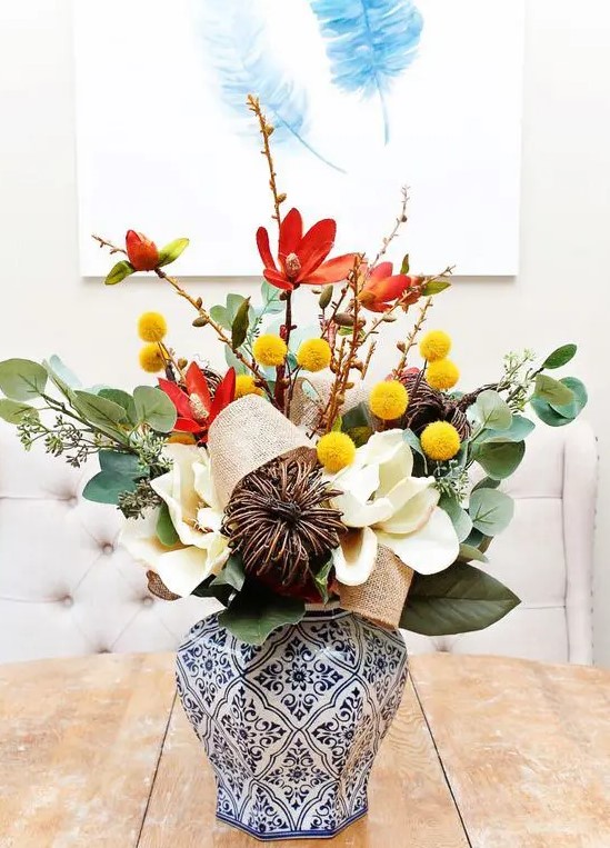 an elegant fall arrangement of leaves, billy balls, vine, burlap and faux white blooms is amazing for decor