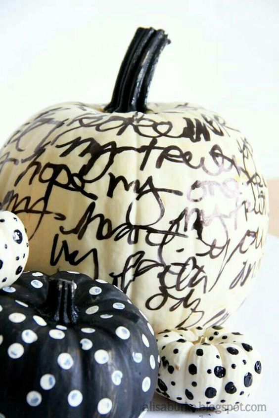 black and white pumpkins decorated with black and white sharpies, with calligraphy and polka dots