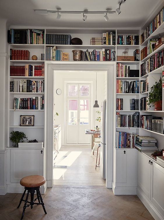 bookcases built around and over the door let you store more books and other stuff and you will save a lot of space