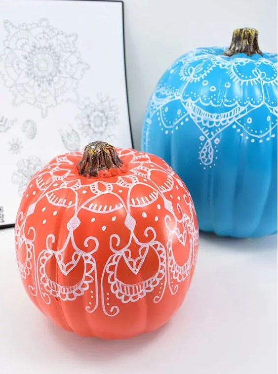 bright pumpkins with henna decor on them to add a colorful touch and a boho feel to the space