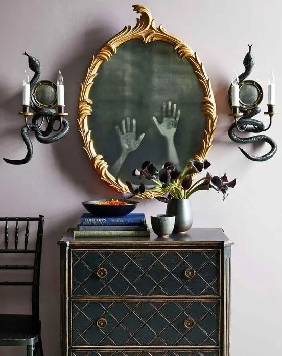 creative mirror decor showing off some ghost hands inside it is a cool and bold idea, all you need to do is to print out