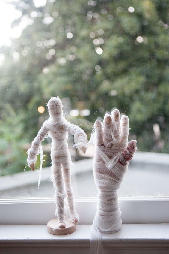 mini mummy decorations like these ones can be easily decorated to make your Halloween party scarier