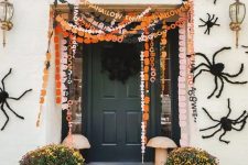 orange, black and white and pink paper Halloween banners with letters are a cool idea for a porch or a mantel