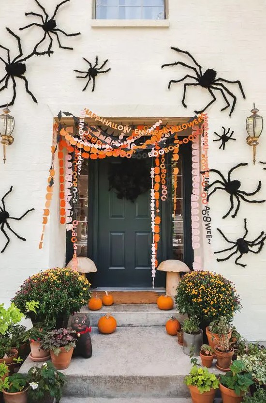 orange, black and white and pink paper Halloween banners with letters are a cool idea for a porch or a mantel