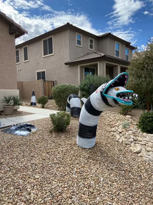 outdoor Halloween decor with a Beetlejuice snake is a super cool and fun idea for your yard