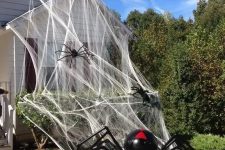 realistic spiderweb and realistic giant black and red spiders will make your house look very Halloween-like, you won’t need other decor