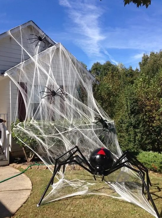 realistic spiderweb and realistic giant black and red spiders will make your house look very Halloween-like, you won't need other decor