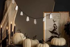 simple Halloween mirror decor with some cheesecloth and a ghost garland is a cool and fast to realize idea