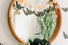 simple and quick Halloween mirror decor with a bat and a skull garland is a cool last-minute solution