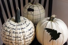 white Halloween pumpkins with a painted blackbird, a spider and some calligraphy are amazing for decor