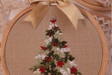 a Christmas ornament of an embroidery hoop with a Christmas tree embroidered is a beautiful solution