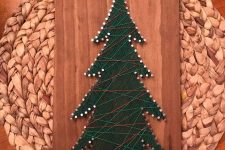 a Christmas tree strign art piece of green, neutral, red yarn is a cool rustic decoration for the holidays