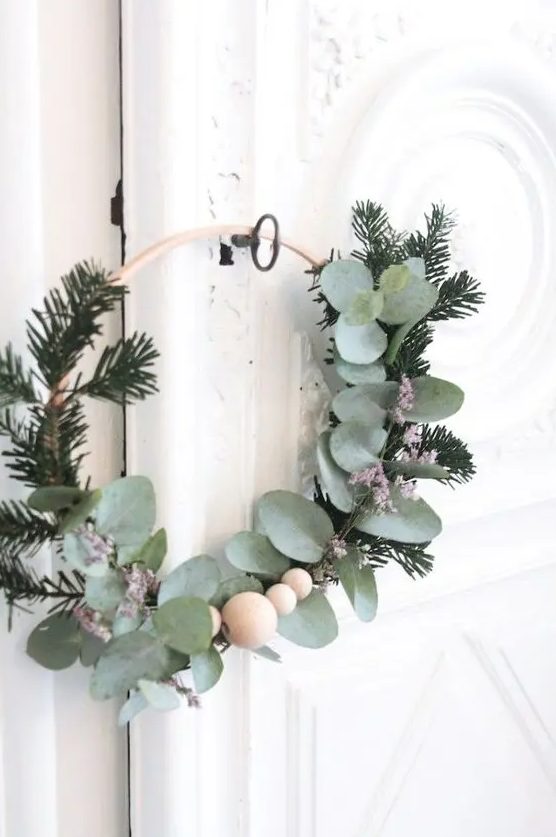 a Scandinavian Christmas wreath with evergreens, eucalyptus and wooden beads is a lovely decoration