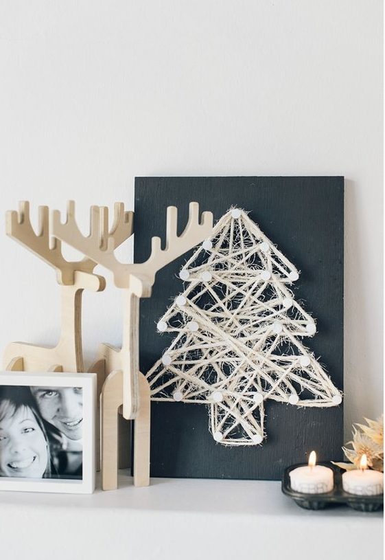 a chalkboard sign with a twine Christmas tree art for a minimalist space