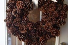 a classic woodland wreath of pinecones with a ribbon bow is a cool decoration for Christmas