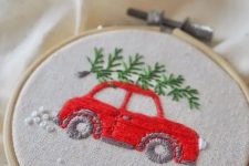 a fun and cool embroidery hoop Christmas ornament with a red car and a tree embroidered is an awesome decor idea