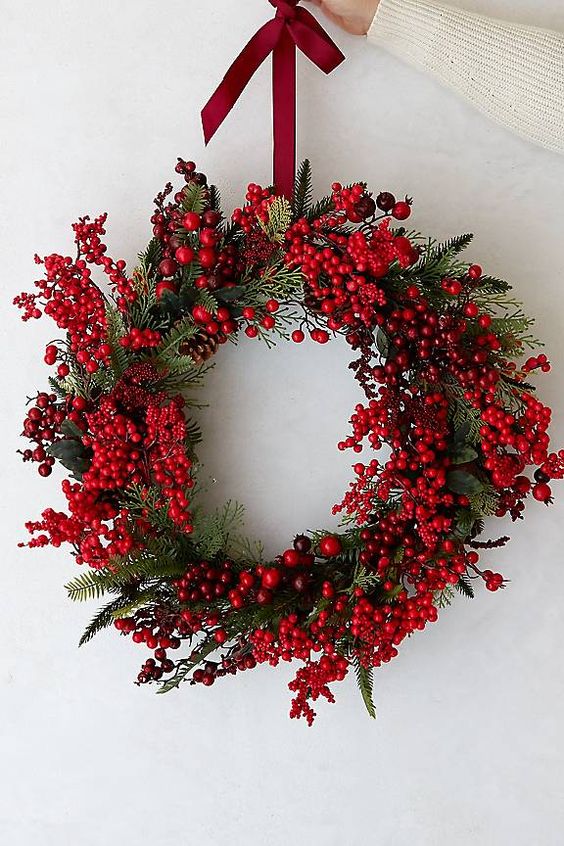 a gorgeous Christmas wreath of greenery and berries is a cool and catchy decor idea for the holidays