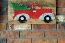 a gorgeous red lorry with a Christmas tree string art for a funny touch, it looks bright and very holiday-inspired