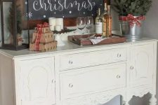 a large chalkboard sign in a stained frame is a great idea for any space to style it for Christmas