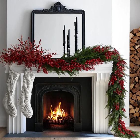 a lush evergreen garland of evergreens, red berries on the mantel is a cool and catchy solution for Christmas
