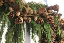 a natural Christmas garland of evergreens and pinecones is a cool and all-natural decoration