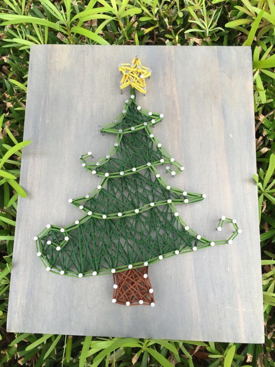 a pretty Christmas string art showing a creative Christmas tree, done with yarn of muted colors, is a cool decoration