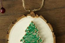 a pretty and cool Christmas ornament of a tree slice and green yarn is amazing for the holidays, it looks cool