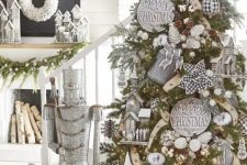 a rustic Christmas tree with pinecones, whitewashed signs, mini churches, pinecones, snowflakes and lights is amazing