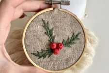 a rustic embroidery hoop Christmas ornament with mistle toe embroidered is awesome