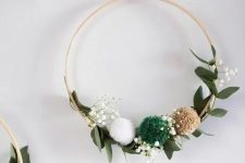 a simple and lovely Christmas embroidery hoop wreath with greenery, baby’s breath and pompoms is a lovely decoration for the holidays