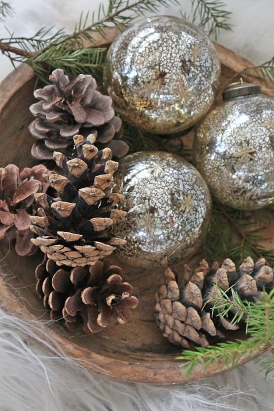 a simple and quick Christmas centerpiece of a wooden bowl, pinecones and mercury glass ornaments is a lovely idea