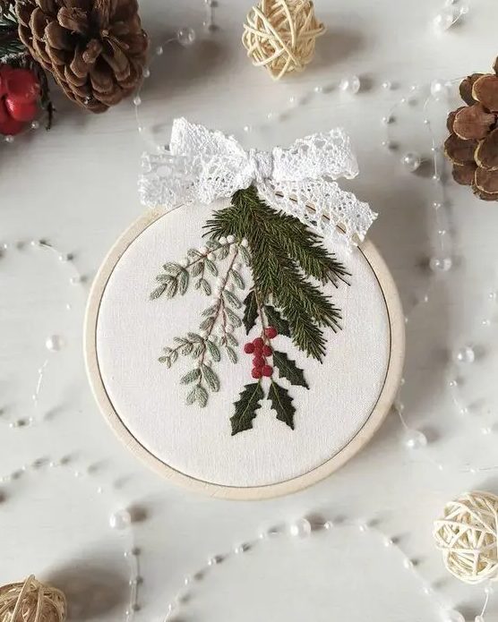 a small and lovely embroidery hoop Christmas ornament with real embroidery and a lace ribbon bow on top