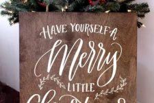 a stained plywood Christmas sign with white calligraphy will fit many decor styles and themes, especially rustic and farmhouse ones
